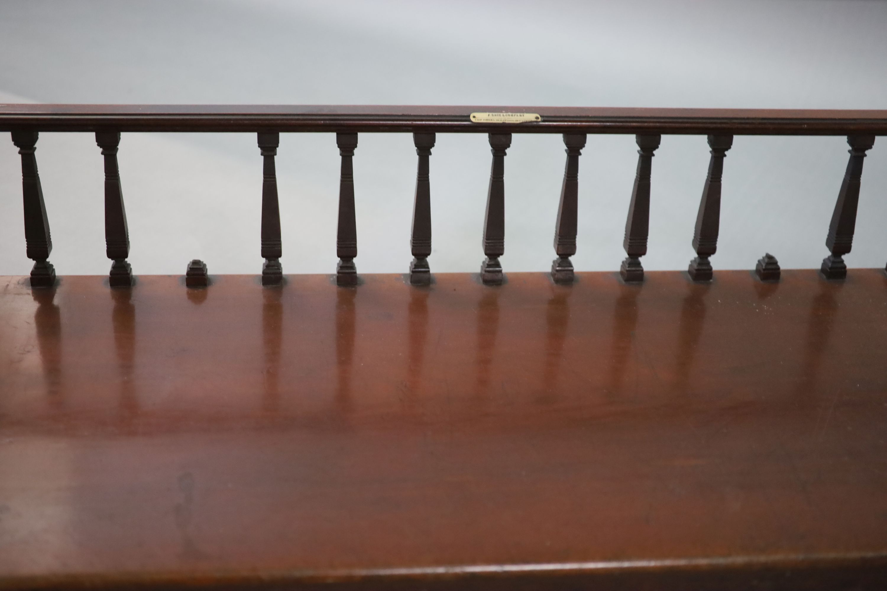 A Victorian mahogany freestanding bookcase, supplied by Sage & Company Shopfitters of London, W.131cm D.51cm H.76cm